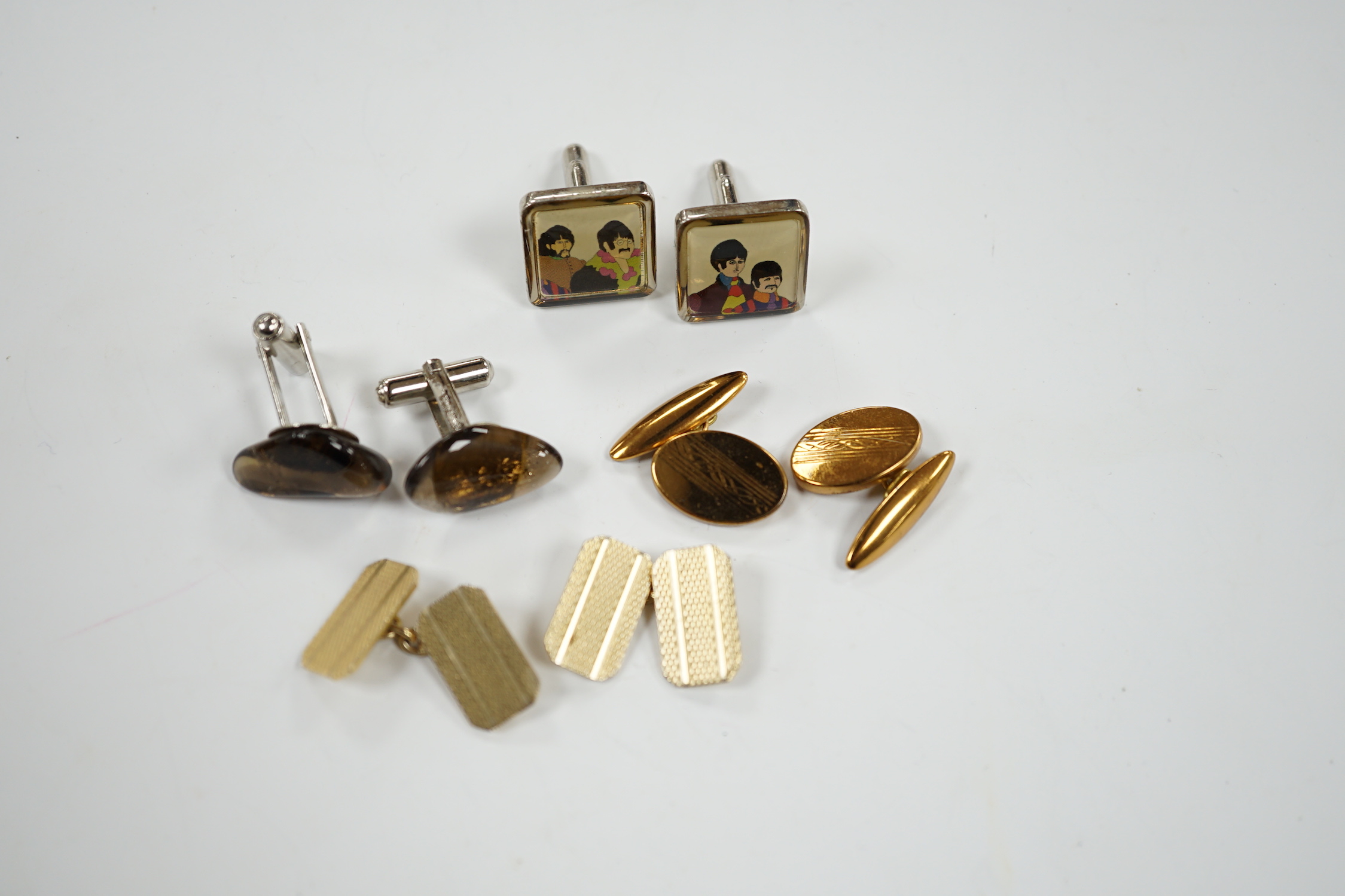 Four assorted pairs of gilt or base metal cufflinks including 'The Beatles'.